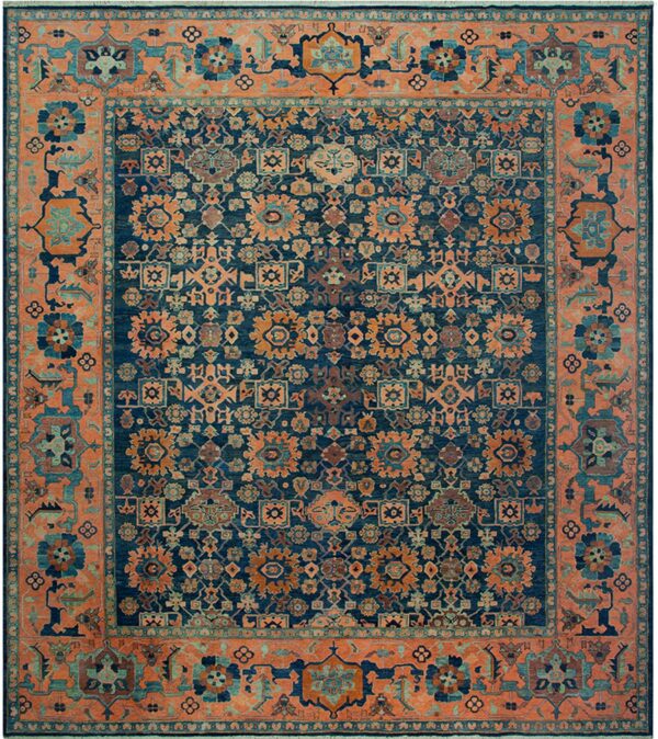 Ornate blue rug with dense floral motifs and a wide coral orange and teal border.