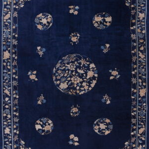 Deep blue high-pile rug featuring beige and pale blue floral medallions and an ornate border.