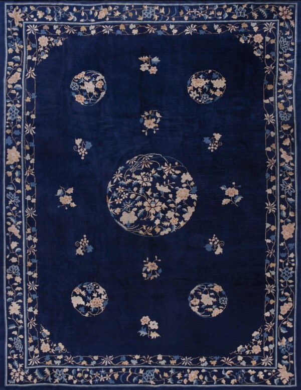 Deep blue high-pile rug featuring beige and pale blue floral medallions and an ornate border.