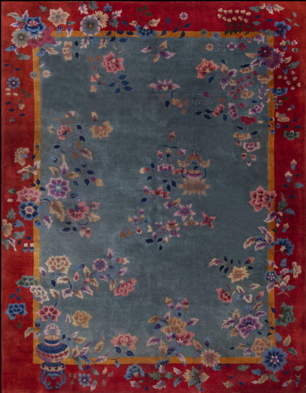 Teal and red rug featuring high pile and elaborate multicolored floral and vase patterns.