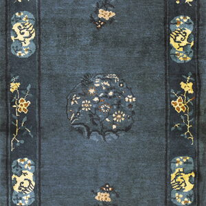 Slate blue rectangular rug featuring traditional floral motifs and medallions in yellow and cream throughout the border.