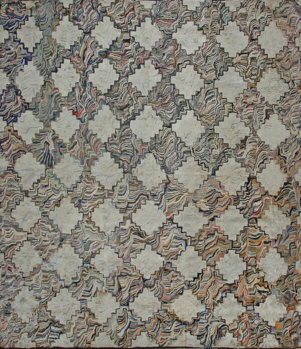 Dense, multicolored textured rug featuring a repeating lattice pattern of light beige diamonds and stepped geometric motifs.