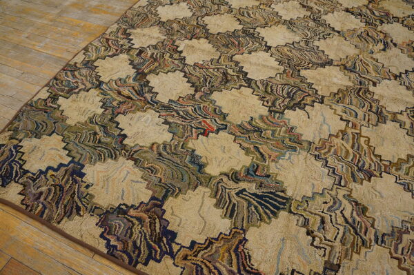 Textured beige rug with a multicolored, jagged geometric pattern rests on distressed wooden floor planks.