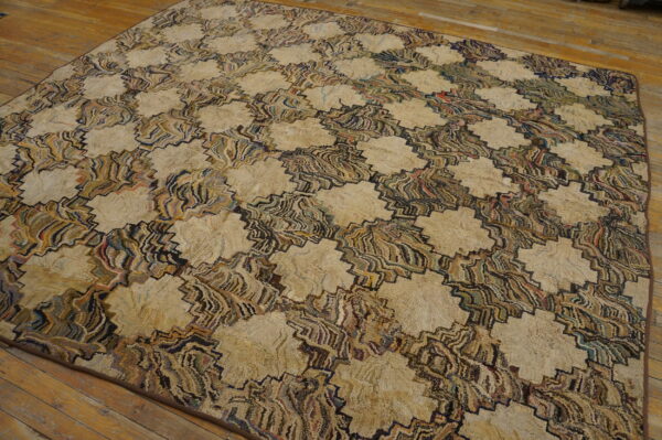 A textured rug with beige floral shapes connected by multicolored zigzagging stripes rests on wood flooring.