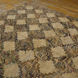 Chunky beige rug with a swirling, multi-colored geometric pattern on rustic hardwood floors.