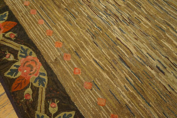 Textured brown and tan rug with diagonal striping, salmon spots, and a dark border with large floral motifs.