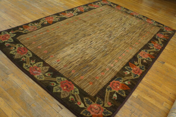 High-texture brown rug with diagonal stripes and a dark floral rose border on hardwood floors.