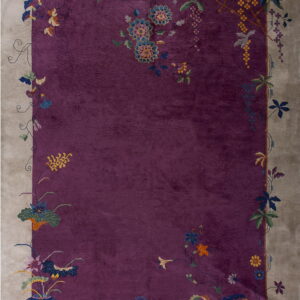 A striking purple rug bordered in taupe, accented with detailed multicolored floral patterns.