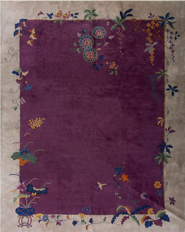 A striking purple rug bordered in taupe, accented with detailed multicolored floral patterns.