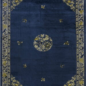Navy blue rug with a central cream floral medallion and wide bordered botanical vine pattern.