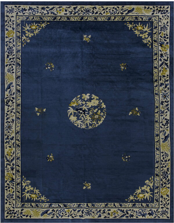 Navy blue rug with a central cream floral medallion and wide bordered botanical vine pattern.