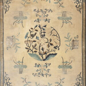 Beige rug with a central bird and flower medallion, bordered by a blue Greek key pattern.