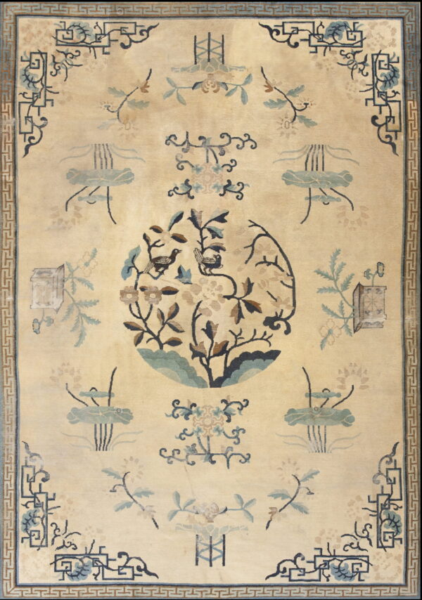 Beige rug with a central bird and flower medallion, bordered by a blue greek key pattern.