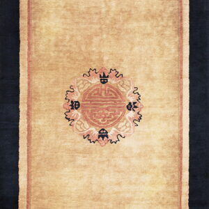 Tan runner rug displaying a central rose medallion and detailed black and pink corner motifs on a solid field.