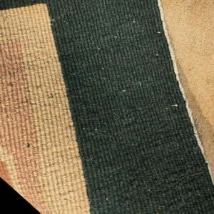 Tan loop pile and dark green low pile texture are visible next to a brown rug backing.