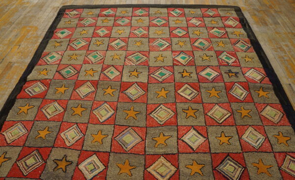 Checkerboard rug with alternating red diamond squares and gray star squares on distressed wood flooring.
