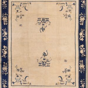 Cream rug featuring deep blue stylized motifs and a wide floral border on rustic wooden plank flooring.