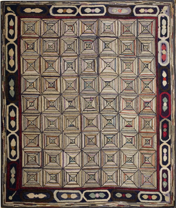 This heavily textured rug features a geometric striped square pattern surrounded by a navy and cream border.