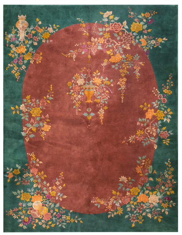 Dark green and maroon rug with a central oval and vibrant floral vines bordering the edge.
