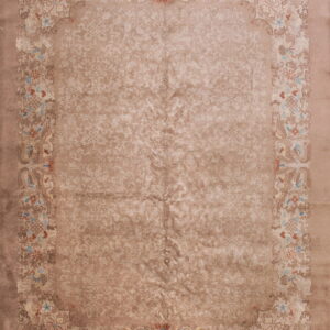 Taupe rug with subtle scrolling field pattern and ornate border featuring birds and blue florals.