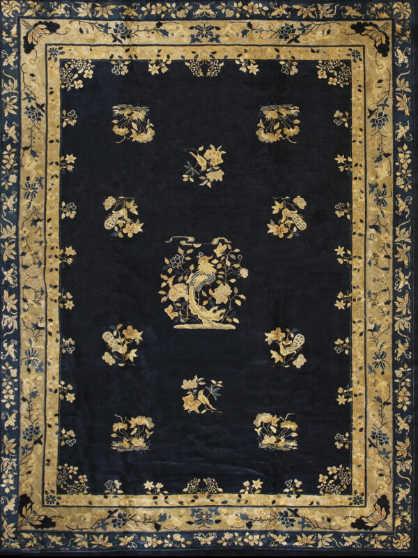 Dark navy rug with a thick pile, featuring gold floral borders and scattered bird medallions.