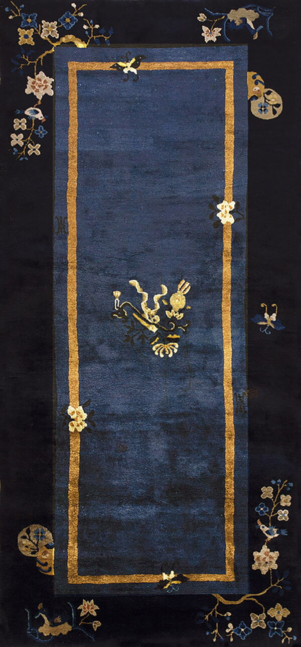 Dark blue runner rug framed by gold stripes, featuring a central gold symbol and black floral borders.
