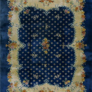 Rich blue rug with a yellow scalloped frame decorated with lush multicolor floral bouquets and ribbons.