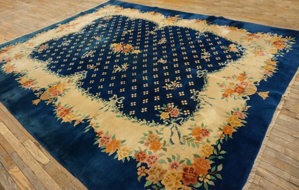 High-pile blue rug featuring a contrasting beige field densely patterned with colorful floral bouquets on wood planks.
