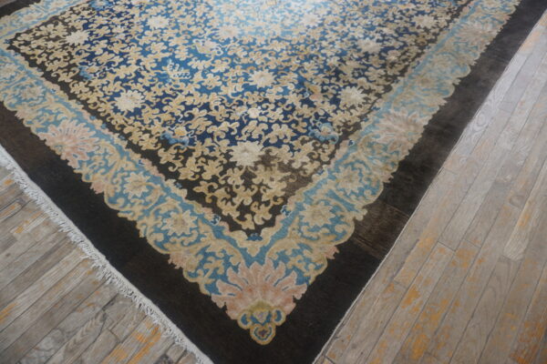 Antique blue chinese rug with floral design.