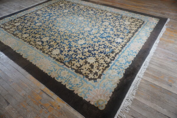 Antique chinese rug with intricate patterns.