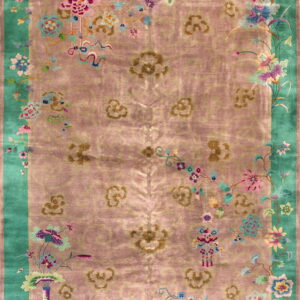Pink rug with a bright teal border and large central floral medallions surrounded by detailed flowering vines.