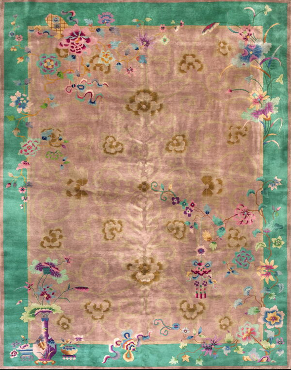 Pink rug with a bright teal border and large central floral medallions surrounded by detailed flowering vines.