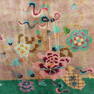 Plush pink rug with stylized colorful flowers and leaves, framed by a bright green border.