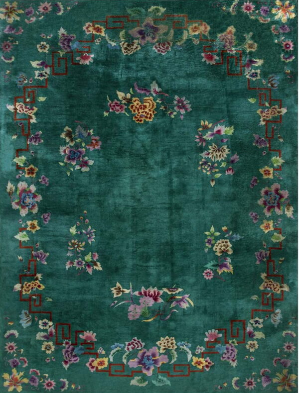 Teal rug with colorful scattered flowers and a thin, rust-colored geometric border frame.