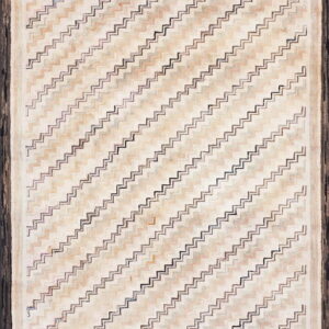 Textured rug with diagonal zigzag pattern in cream and tan, featuring a thick dark brown border.