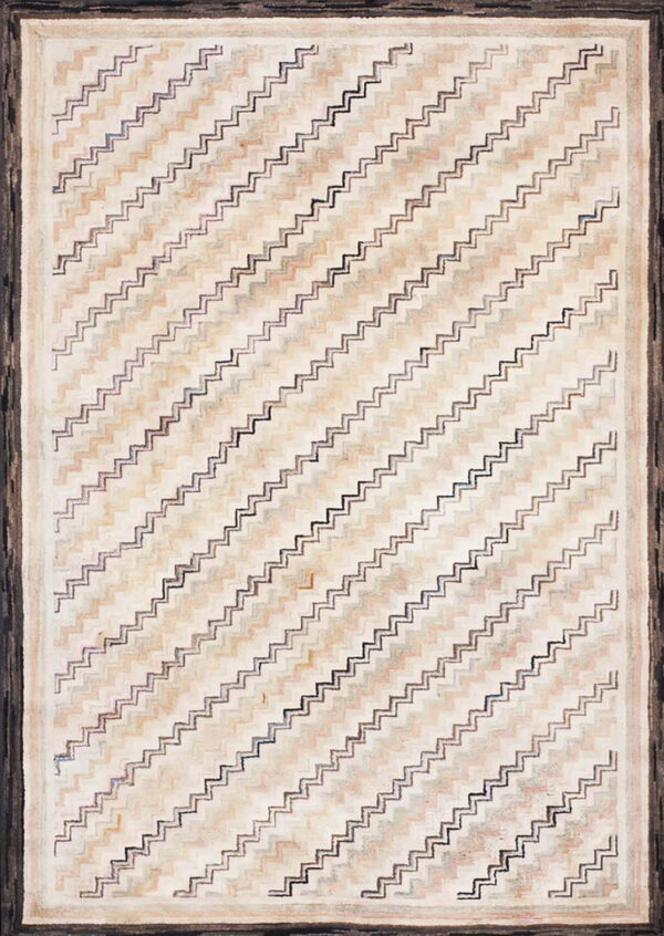 Textured rug with diagonal zigzag pattern in cream and tan, featuring a thick dark brown border.
