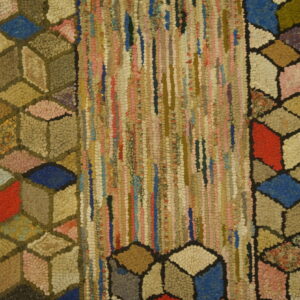Textured rug displaying multicolored cubes flanking a center panel of chunky vertical fabric strips.