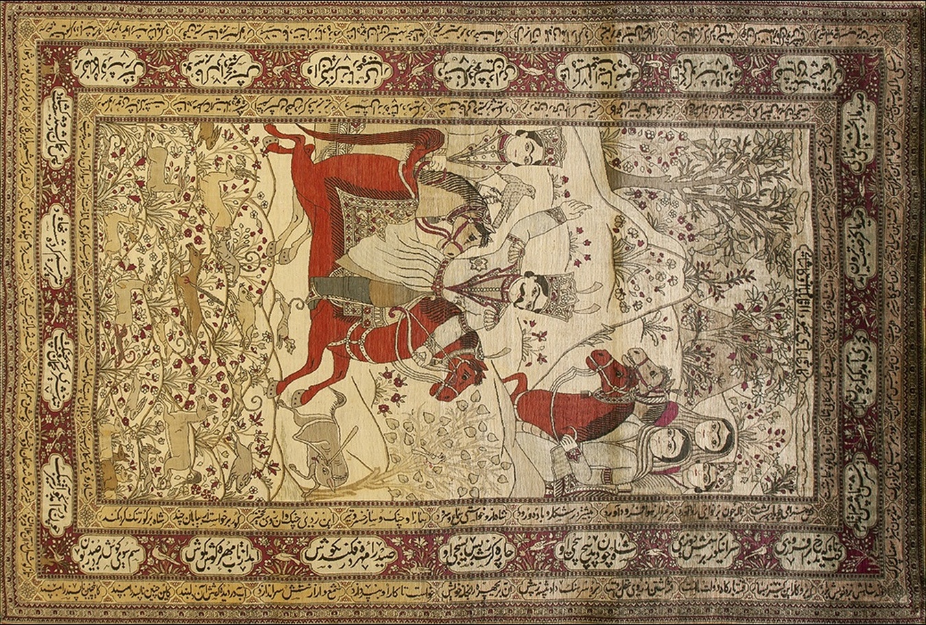 Close-up detail of a handmade antique area rug showing low pile texture and faded colors - by rugs on net