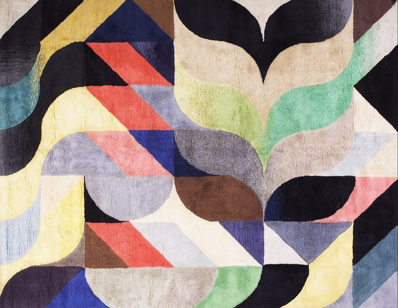 Detailed shot of the antique rug's worn pile, showcasing the faded red, blue, and gold tribal pattern - by rugs on net