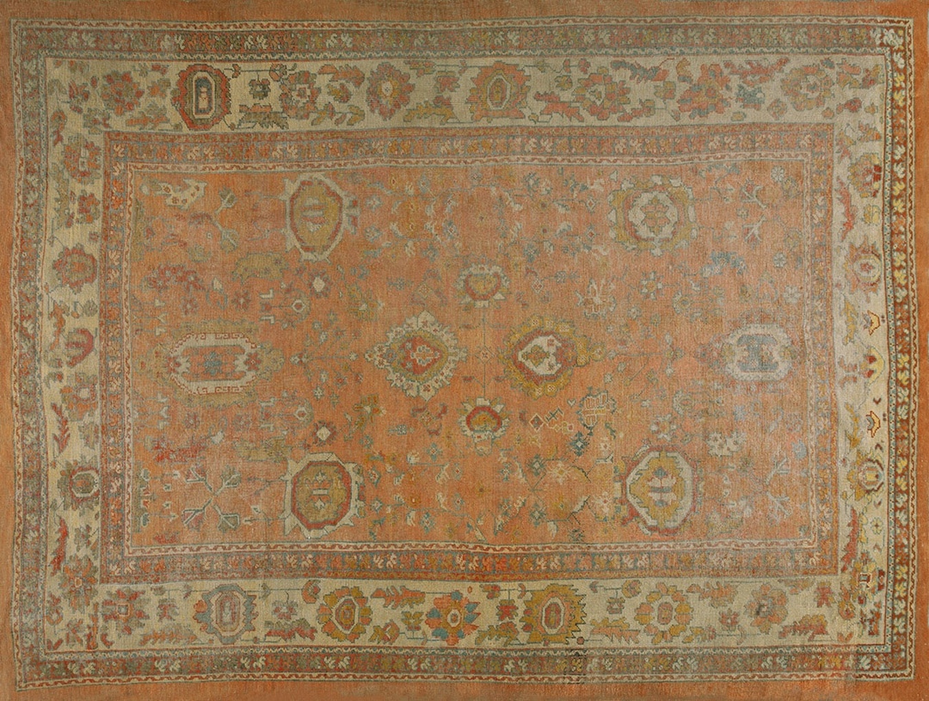 An antique hand-knotted wool rug featuring an allover floral pattern in coral and salmon pink tones - by rugs on net