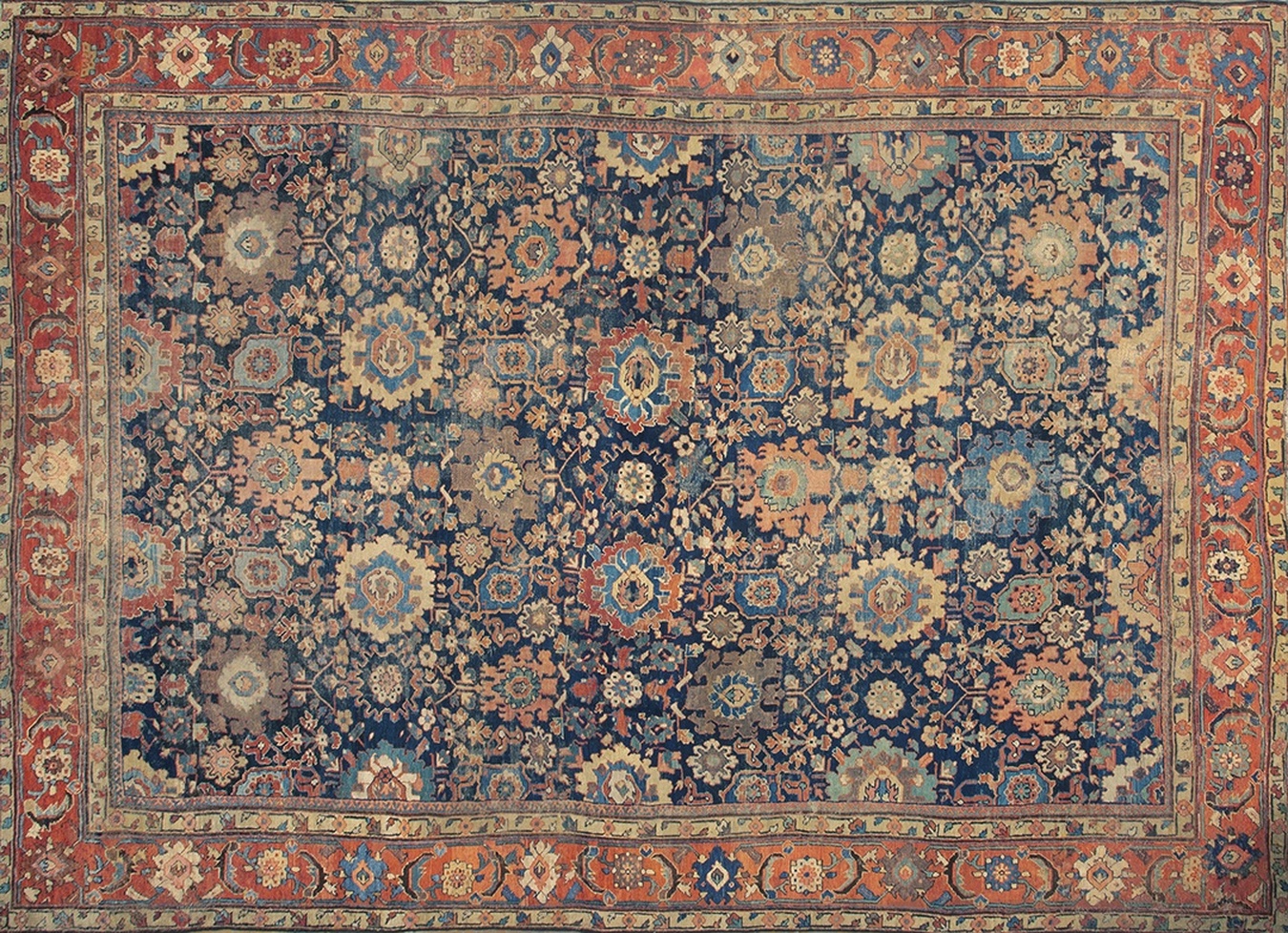 Antique persian rug displaying a faded allover pattern of rust, cream, and subtle blue - by rugs on net