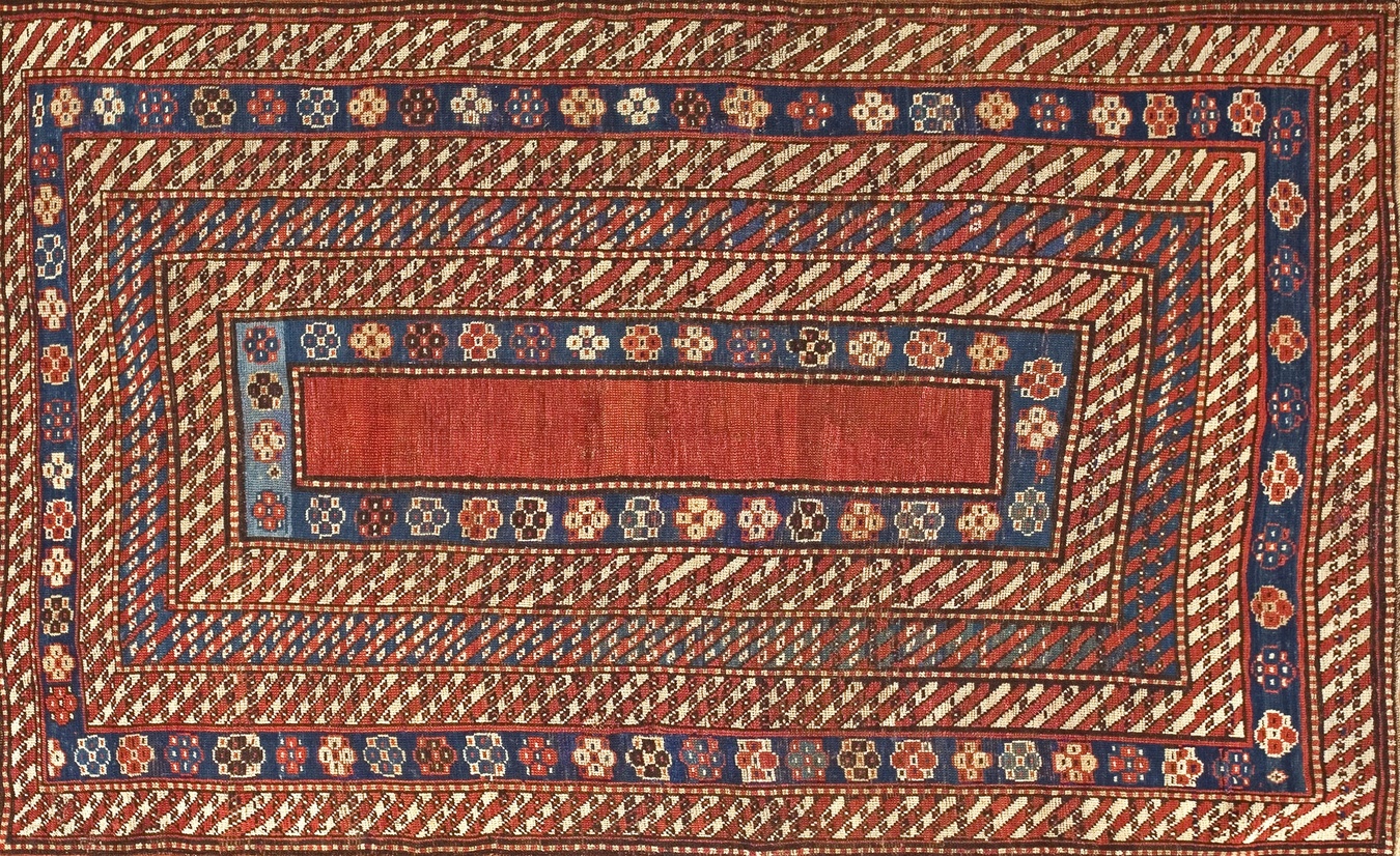 Full view of antique 1890s caucasian rug featuring a coral field and detailed geometric motifs - by rugs on net