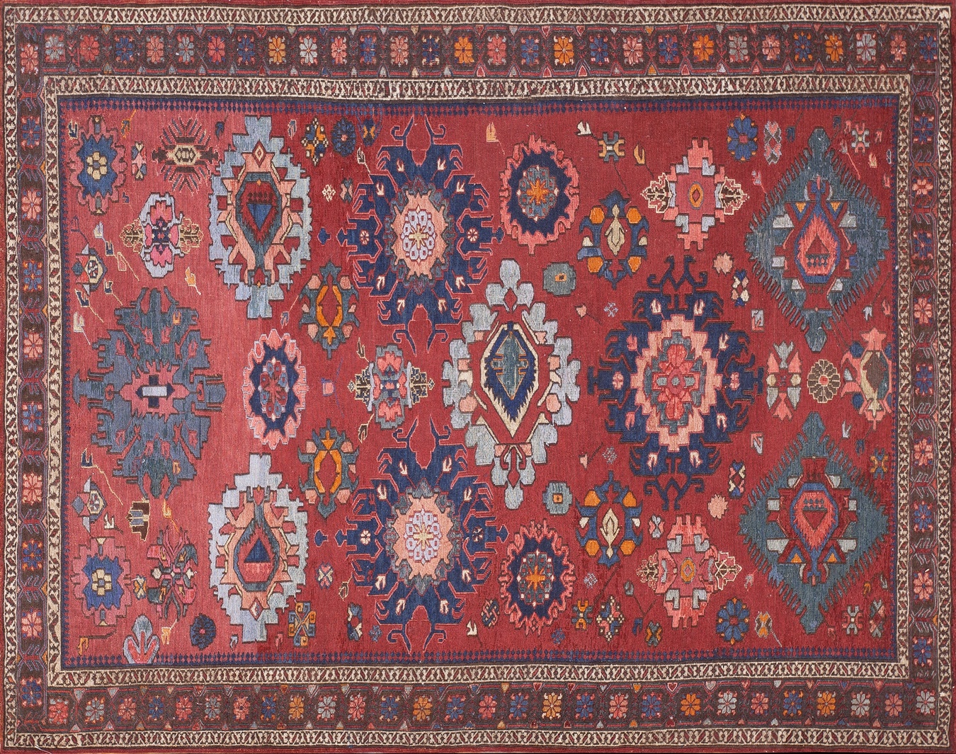 Small antique sumak caucasian scatter rug featuring deep coral, navy, and ivory geometric motifs - by rugs on net