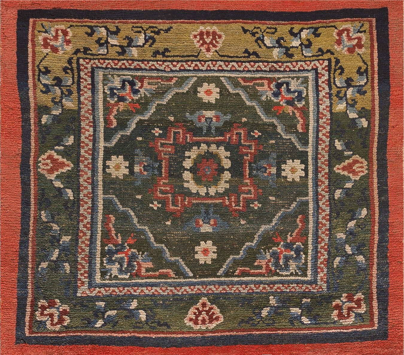 Full view of antique tibetan chinese knotted rug featuring ivory field and blue floral border - by rugs on net