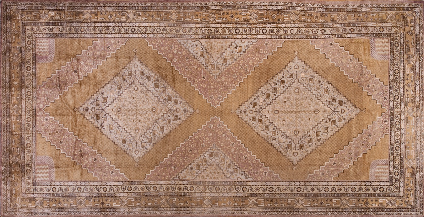 Large antique khotan wool rug in coral and pink tones featuring a central medallion - rugs of central asia by rugs on net