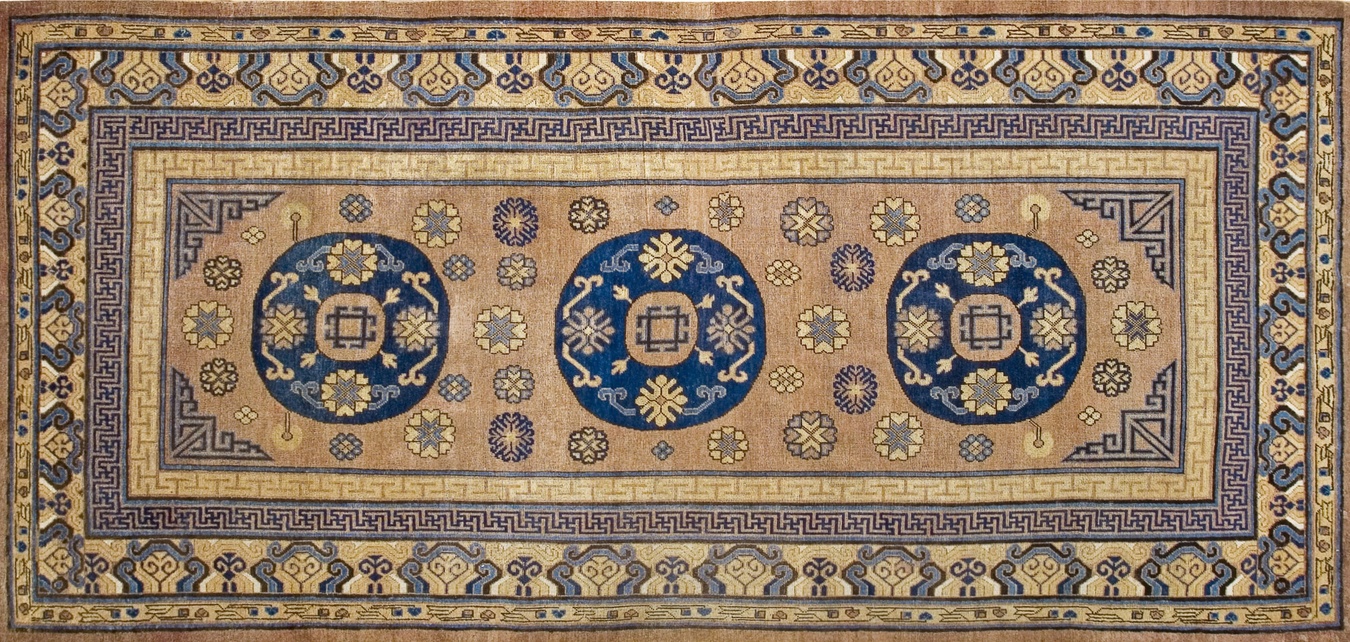 Full view of an antique khotan rug featuring muted tones and traditional geometric medallions - by rugs on net