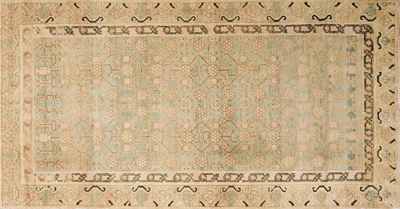 Antique khotan rug with central medallion and subtle geometric motifs in warm yellow and terracotta tones - by rugs on net