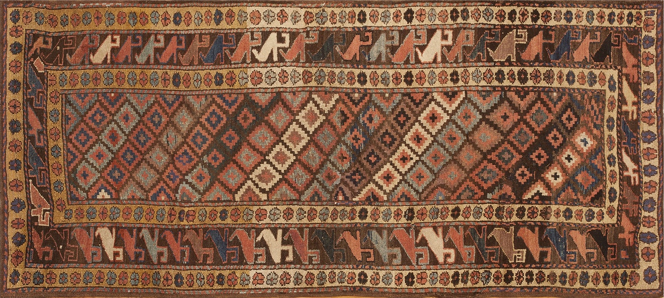 Full view of an antique kurdish persian geometric knotted runner rug with deep red and blue dyes - by rugs on net
