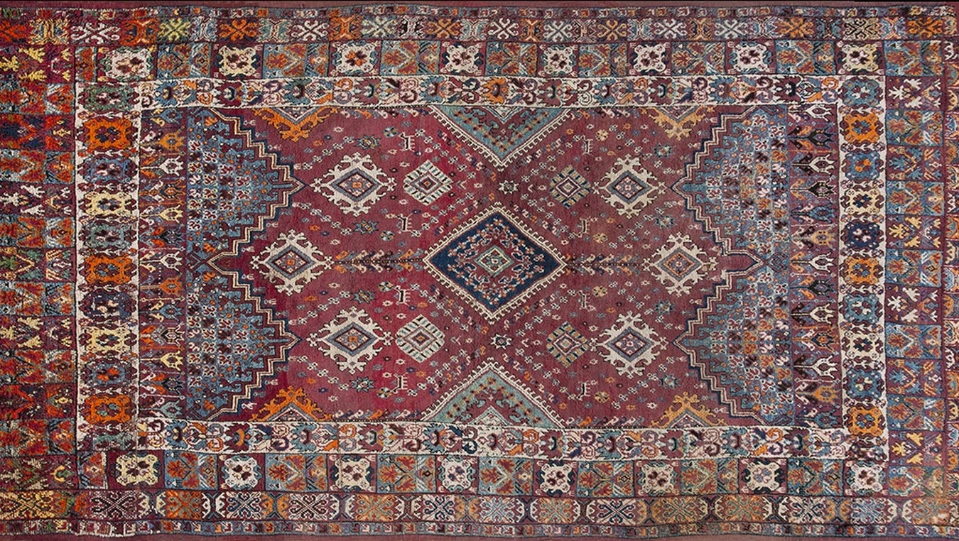 Antique, room-sized moroccan rabat wool rug displaying traditional red and blue geometric patterns - by rugs on net