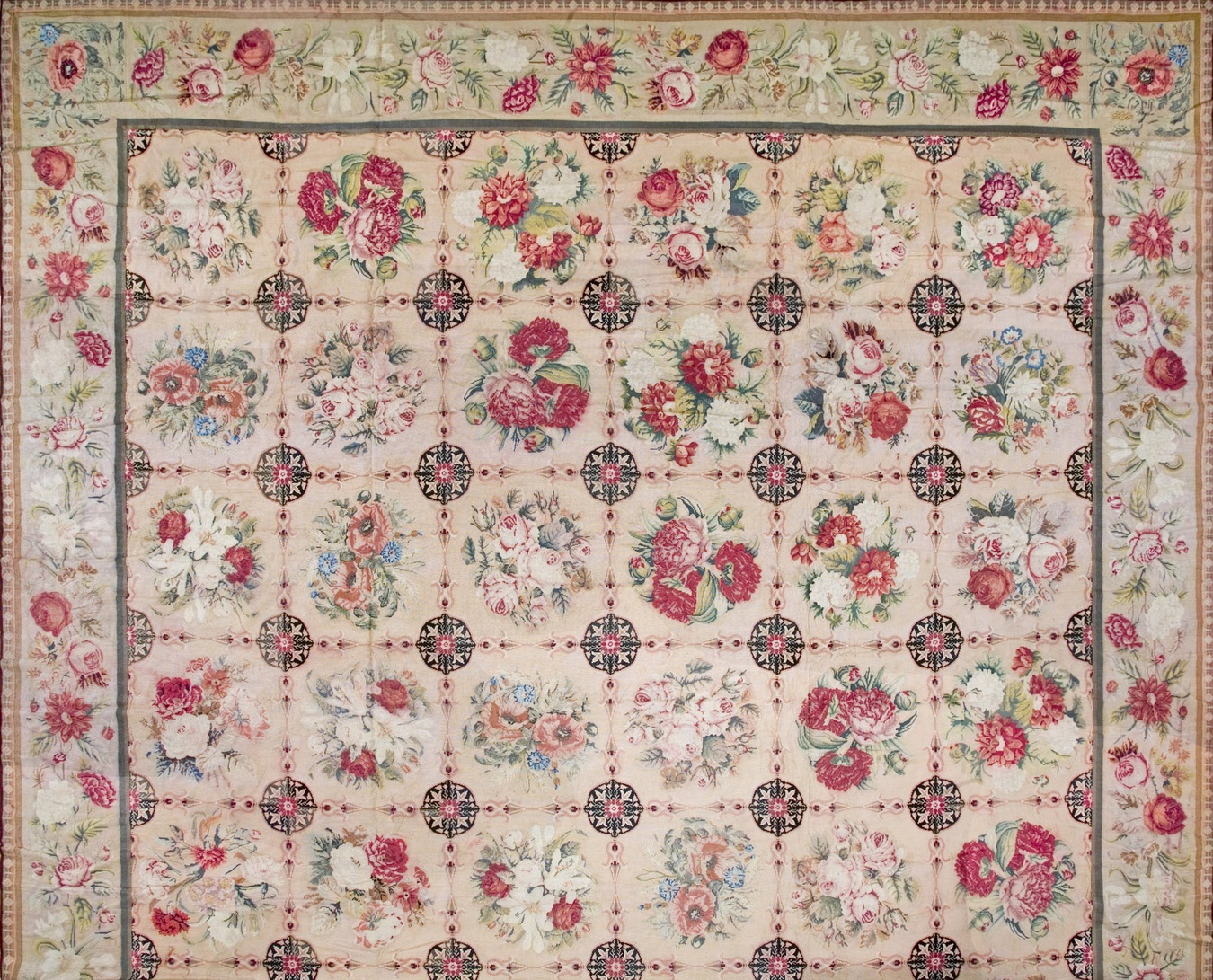 Antique needlepoint rug featuring intricate pastel floral and vine patterns - by rugs on net
